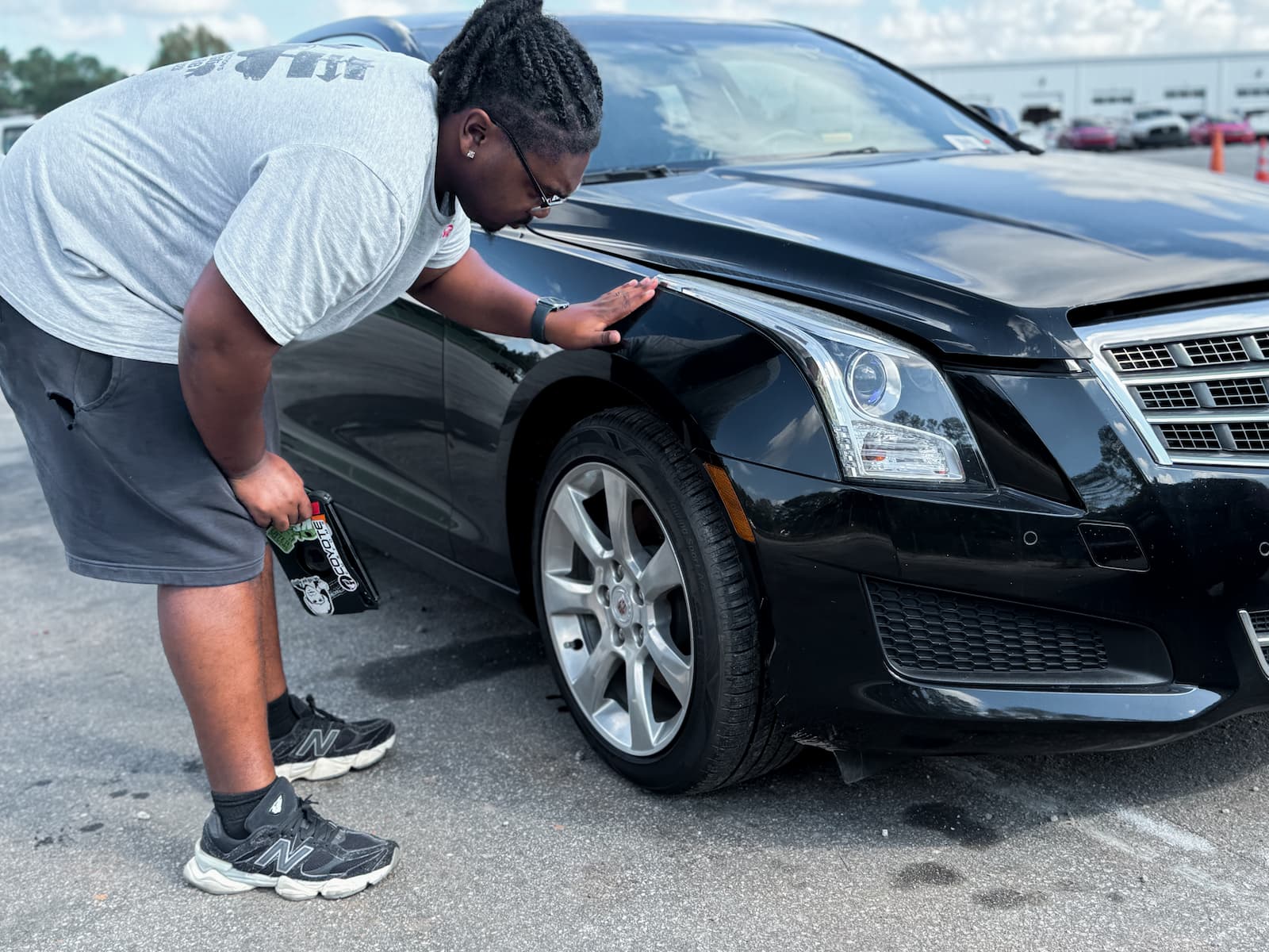 man inspecting condition of car